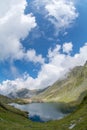 Balea lake and Balea Hotel in spring time with clouds Royalty Free Stock Photo